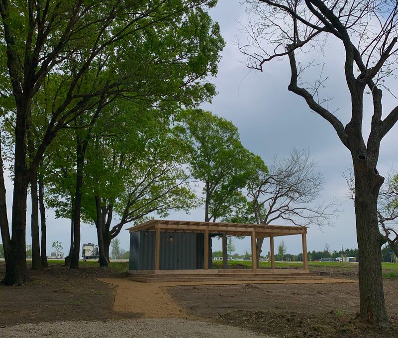 Bathhouse building with cedar pergola in the trees